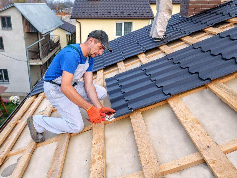 roofer aligns panels for roofing job requirements