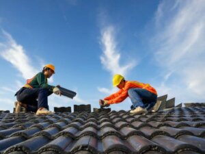 roofers placing tiles on roof for roofing license