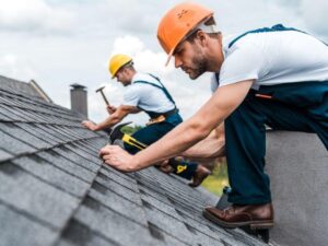 roofing team repairing shingles on a residential roof